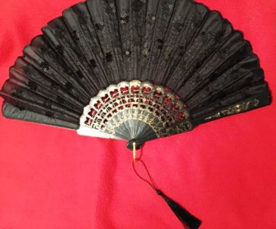 gothic black sequined victorian wedding fan with tassel red background